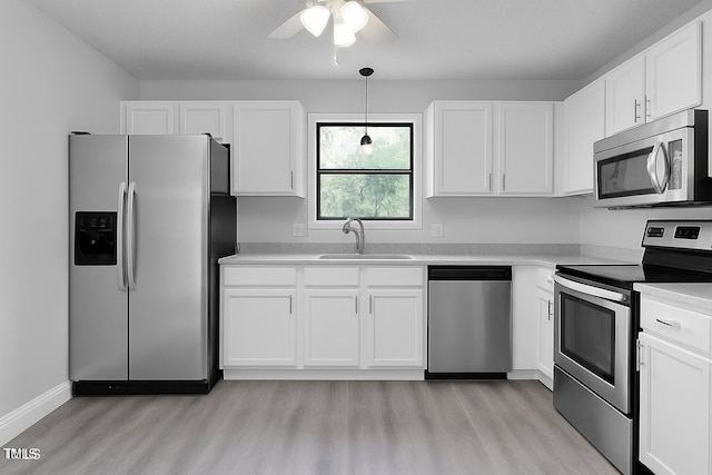 1517 Laughridge Dr, Cary, NC 27511 - kitchen with appliances with stainless steel finishes, light wood-style flooring, a ceiling fan, and white cabinets