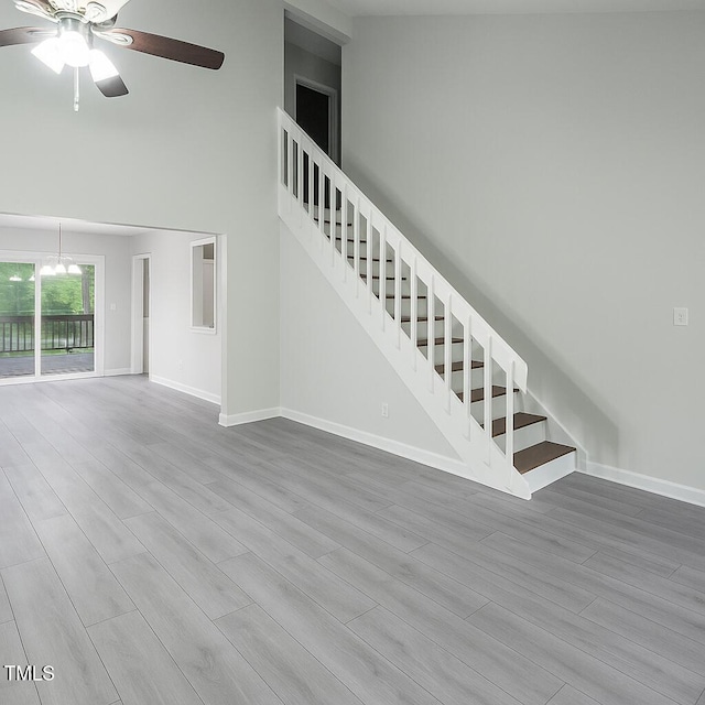 1517 Laughridge Dr, Cary, NC 27511 - unfurnished living room featuring stairs, a ceiling fan, and wood finished floors