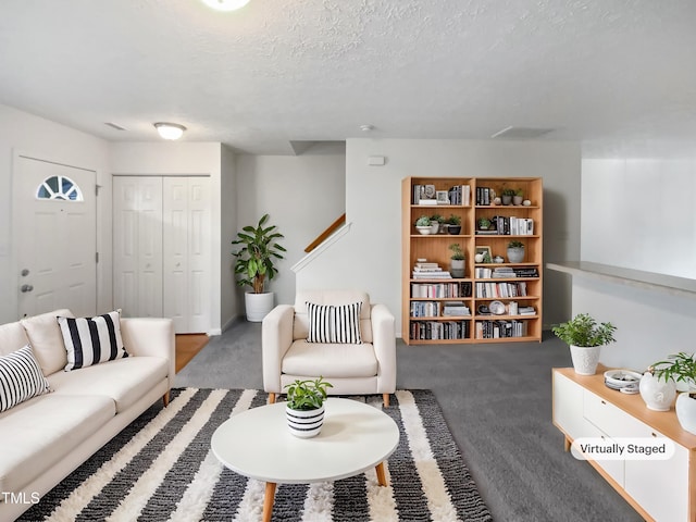 carpeted living room with a textured ceiling