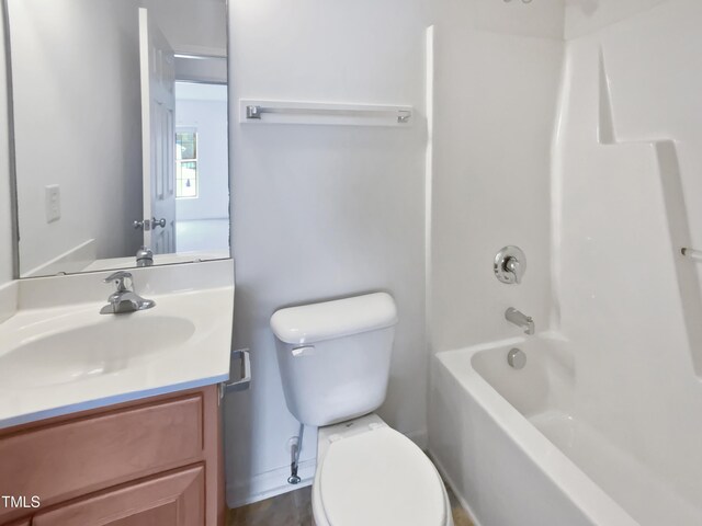 full bathroom featuring toilet, vanity, and  shower combination
