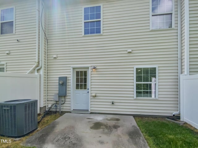 back of house with a patio, central air condition unit, and fence