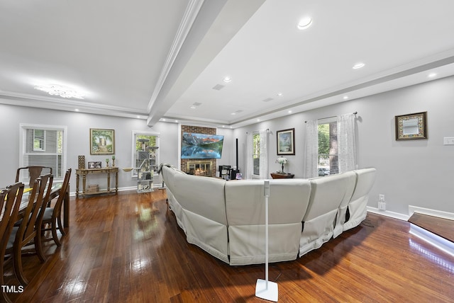 living room featuring crown molding, a fireplace, recessed lighting, baseboards, and dark wood-style floors