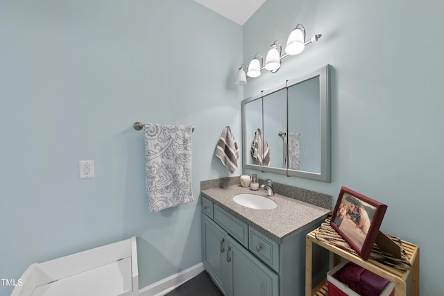 bathroom with vanity and baseboards