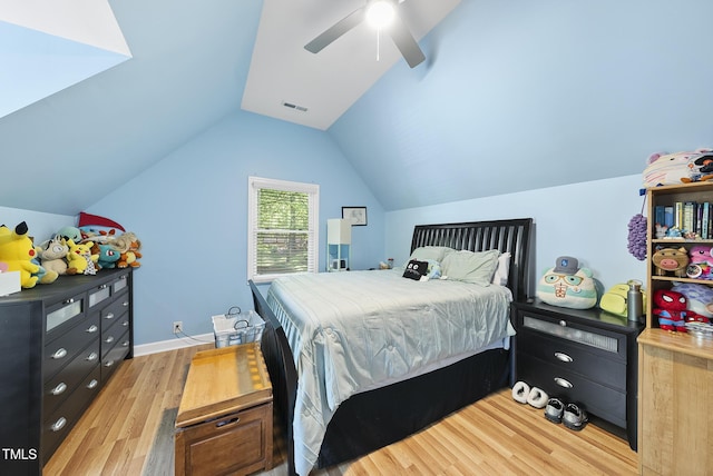 bedroom with baseboards, vaulted ceiling, light wood-style flooring, a ceiling fan, and visible vents