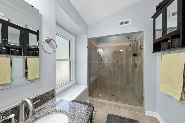 full bath featuring visible vents, tile patterned floors, a shower stall, and lofted ceiling