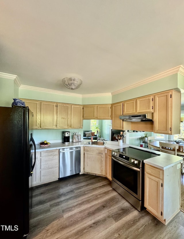 kitchen with under cabinet range hood, appliances with stainless steel finishes, ornamental molding, and light brown cabinets
