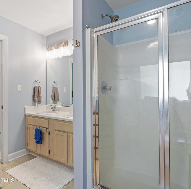 bathroom featuring vanity, tile patterned flooring, and a shower stall