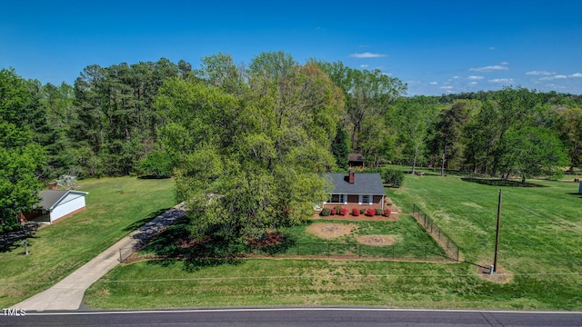 birds eye view of property with a view of trees