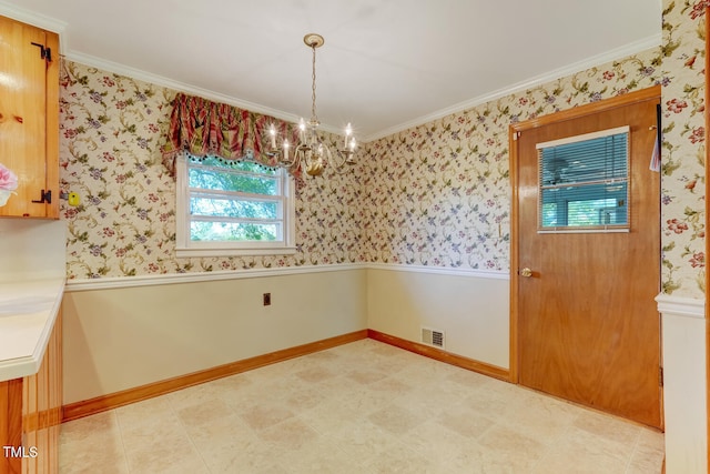 unfurnished dining area featuring crown molding, an inviting chandelier, baseboards, and plenty of natural light