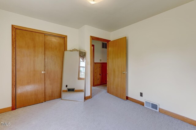 unfurnished bedroom featuring carpet flooring, baseboards, and visible vents