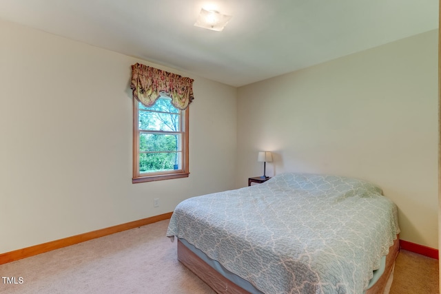 bedroom with baseboards and carpet floors