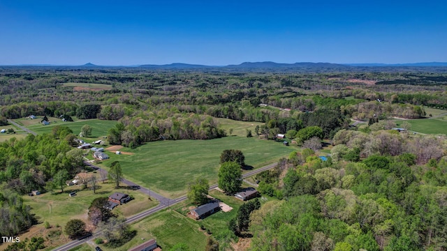birds eye view of property featuring a view of trees