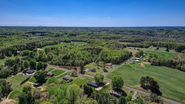 drone / aerial view featuring a view of trees