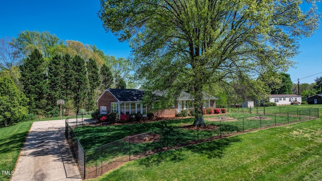 view of yard featuring fence and driveway