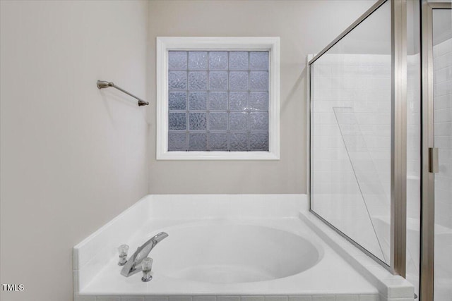 full bath with a garden tub and a stall shower