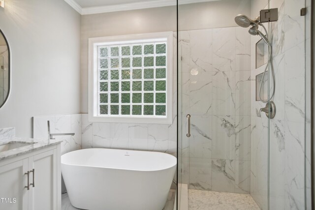 3332 Cheswick Dr, Raleigh, NC 27609 - full bath featuring a freestanding tub, vanity, ornamental molding, tile walls, and a marble finish shower