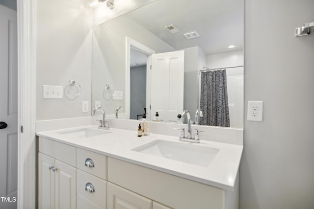 3332 Cheswick Dr, Raleigh, NC 27609 - full bath with double vanity, a sink, and visible vents
