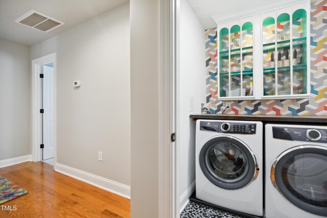 3332 Cheswick Dr, Raleigh, NC 27609 - laundry area with laundry area, separate washer and dryer, visible vents, wood finished floors, and baseboards
