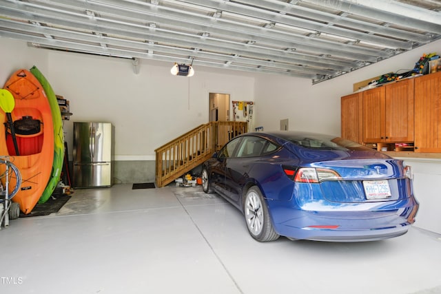 3332 Cheswick Dr, Raleigh, NC 27609 - garage featuring a garage door opener and freestanding refrigerator