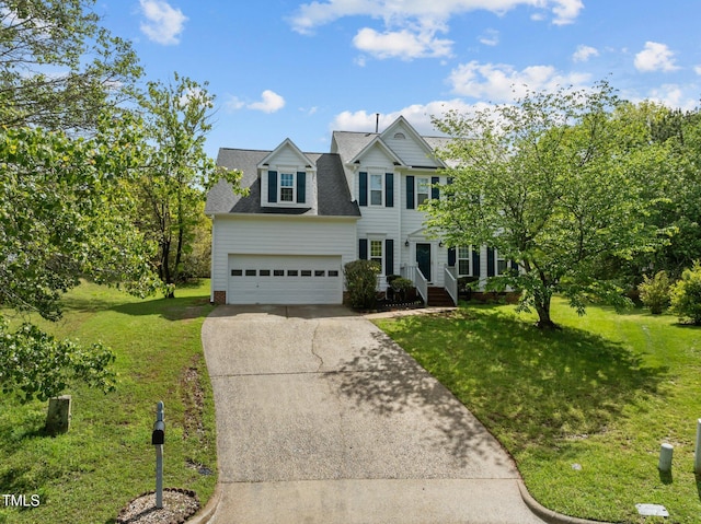 colonial-style house featuring roof with shingles, concrete driveway, a garage, and a front lawn