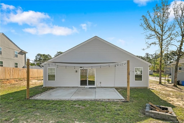 back of house featuring a patio, a yard, and fence