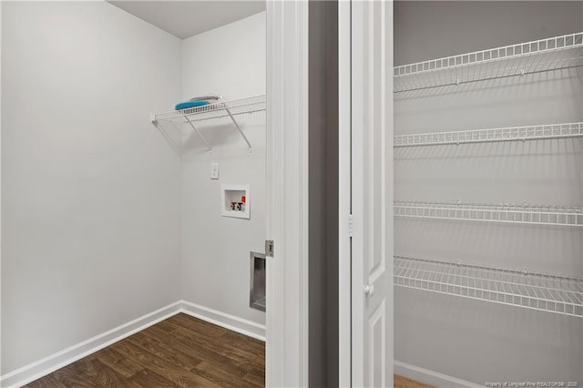 clothes washing area with baseboards, dark wood-style floors, laundry area, and washer hookup