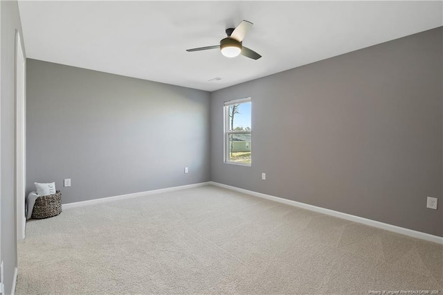 unfurnished room featuring baseboards, a ceiling fan, and light carpet