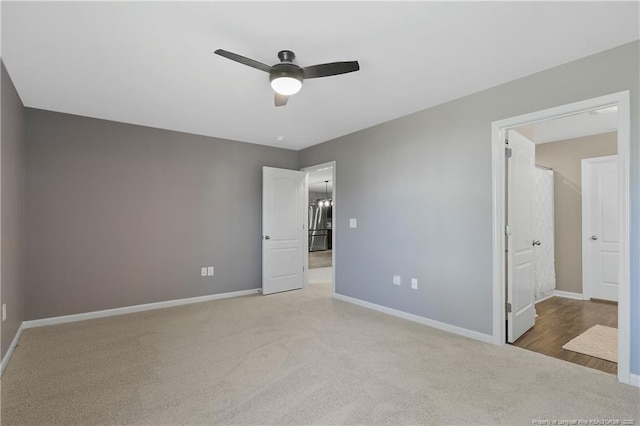 unfurnished bedroom featuring carpet, baseboards, and ceiling fan