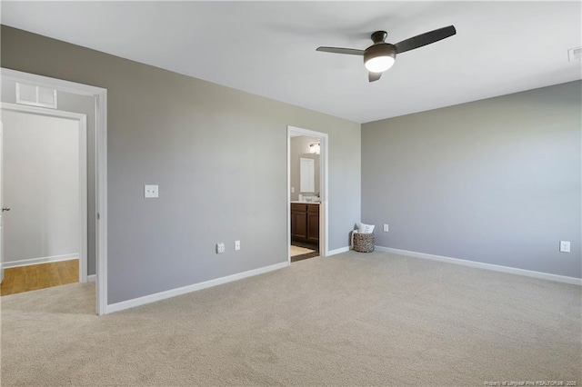 unfurnished bedroom featuring baseboards and light carpet