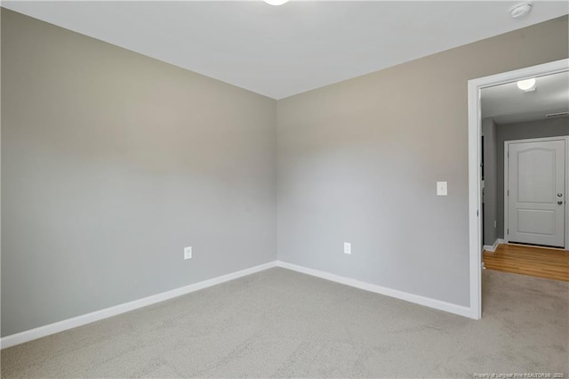 carpeted spare room with baseboards