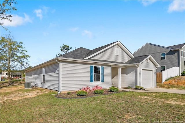 view of front facade with central air condition unit, fence, a front lawn, an attached garage, and concrete driveway