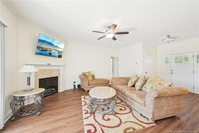 2140 Smith Rd, Hope Mills, NC 28348 - living area with crown molding, wood finished floors, ceiling fan, and a tile fireplace