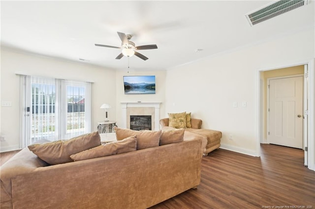 2140 Smith Rd, Hope Mills, NC 28348 - living area featuring ceiling fan, a glass covered fireplace, visible vents, dark wood-style flooring, and baseboards