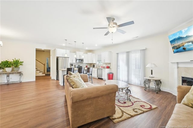 2140 Smith Rd, Hope Mills, NC 28348 - living area with baseboards, a ceiling fan, a fireplace, wood finished floors, and stairs