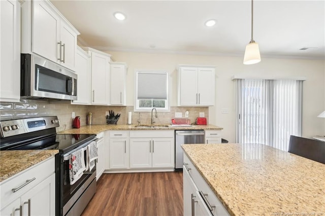 2140 Smith Rd, Hope Mills, NC 28348 - kitchen featuring backsplash, crown molding, white cabinets, stainless steel appliances, and a sink
