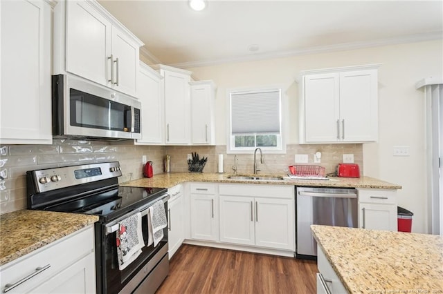 2140 Smith Rd, Hope Mills, NC 28348 - kitchen with white cabinets, a sink, crown molding, and appliances with stainless steel finishes