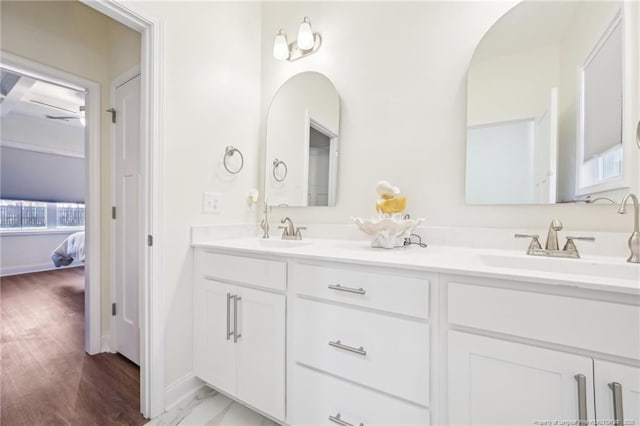 2140 Smith Rd, Hope Mills, NC 28348 - bathroom featuring double vanity, a sink, baseboards, and connected bathroom