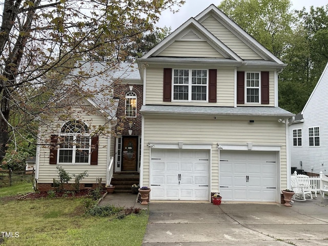 traditional-style home with driveway, an attached garage, and crawl space