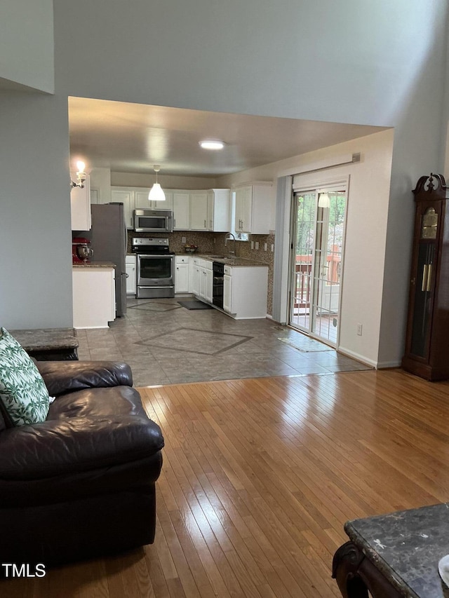 living room with light wood-type flooring and baseboards
