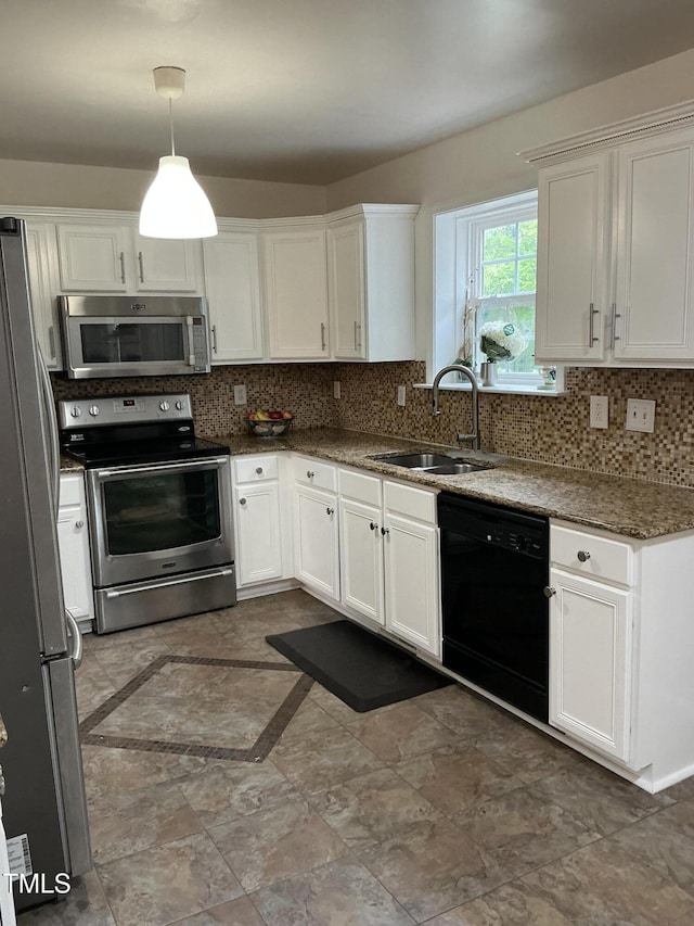 kitchen with tasteful backsplash, white cabinets, decorative light fixtures, a sink, and stainless steel appliances