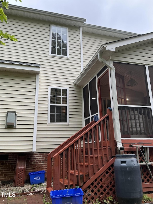 view of side of property featuring a sunroom