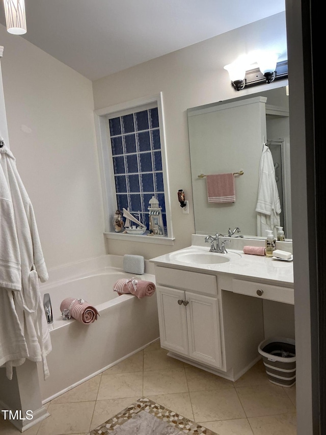 bathroom featuring tile patterned flooring, vanity, and a bath