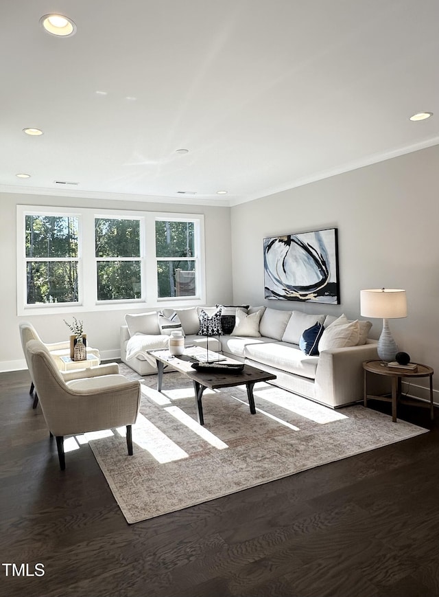 living room featuring dark wood-type flooring, crown molding, baseboards, and recessed lighting