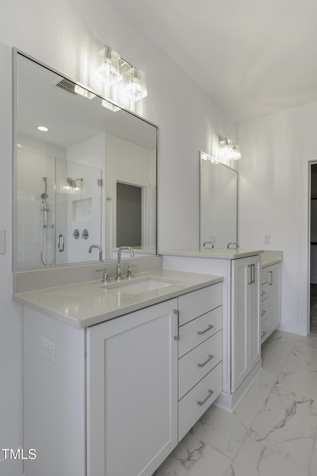 full bathroom featuring a shower stall, marble finish floor, baseboards, and vanity