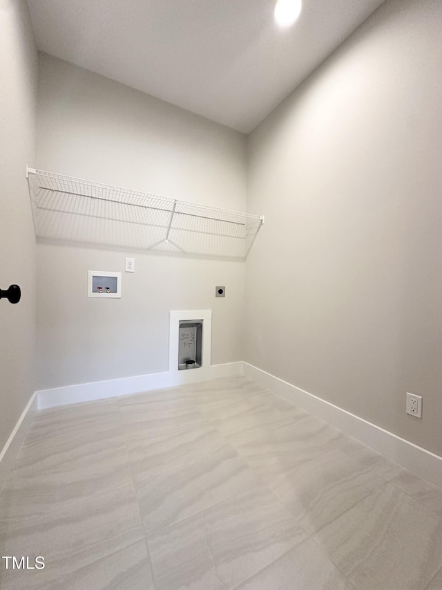 clothes washing area featuring baseboards, hookup for an electric dryer, hookup for a washing machine, and laundry area