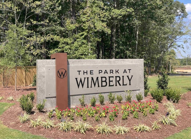 community sign featuring fence