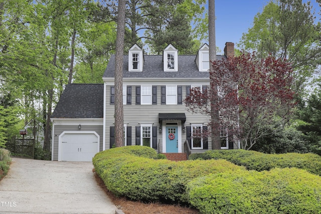117 Vicksburg Dr, Cary, NC 27513 - colonial house featuring a garage, driveway, a chimney, and roof with shingles