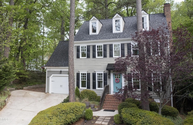 117 Vicksburg Dr, Cary, NC 27513 - colonial-style house featuring a chimney, an attached garage, driveway, and a shingled roof