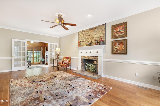117 Vicksburg Dr, Cary, NC 27513 - living area with hardwood / wood-style floors, a stone fireplace, visible vents, french doors, and ceiling fan