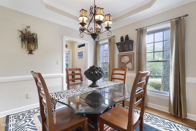 117 Vicksburg Dr, Cary, NC 27513 - dining area featuring a notable chandelier, crown molding, a raised ceiling, and plenty of natural light
